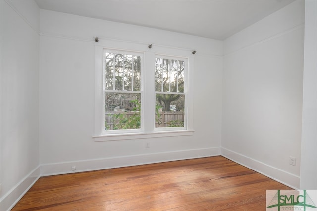 unfurnished room with wood-type flooring