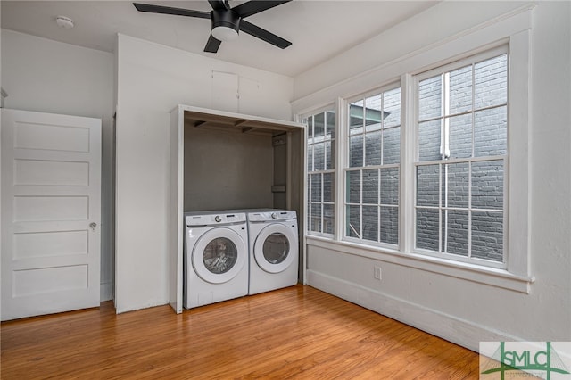 laundry room featuring washing machine and dryer, hardwood / wood-style flooring, and ceiling fan