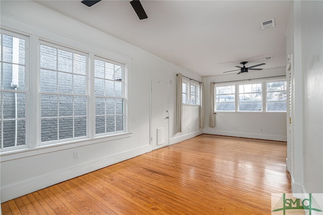 unfurnished sunroom featuring ceiling fan