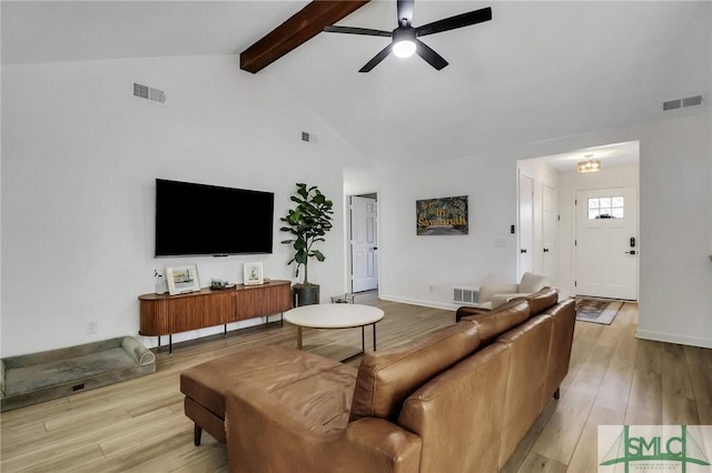 living room featuring vaulted ceiling with beams, ceiling fan, and light wood-type flooring