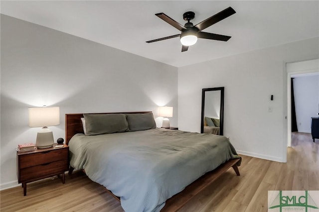 bedroom with ceiling fan and light hardwood / wood-style flooring