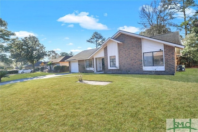 view of front facade with a front yard, a garage, and cooling unit