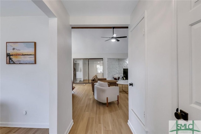 living room featuring light hardwood / wood-style floors and ceiling fan