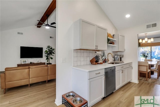 kitchen with dishwasher, sink, vaulted ceiling with beams, tasteful backsplash, and white cabinetry