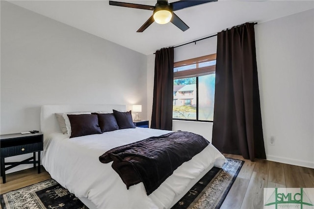 bedroom with light wood-type flooring and ceiling fan