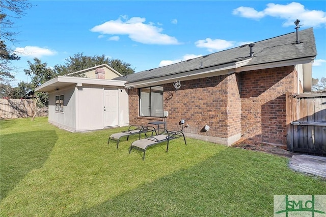 rear view of house with a yard