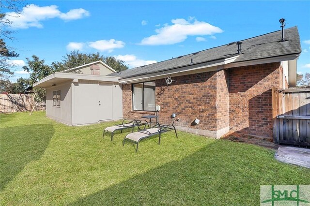 rear view of house with a yard