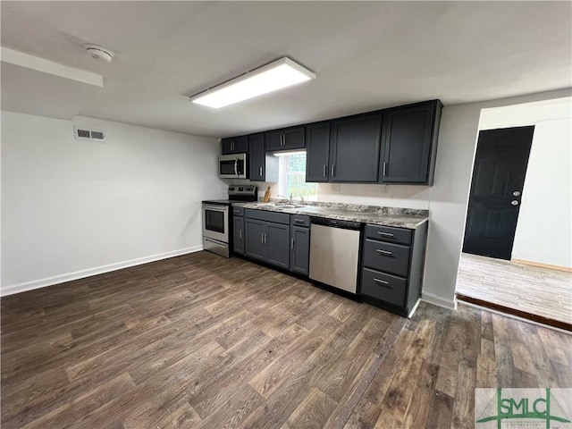 kitchen featuring dark hardwood / wood-style floors, sink, and stainless steel appliances