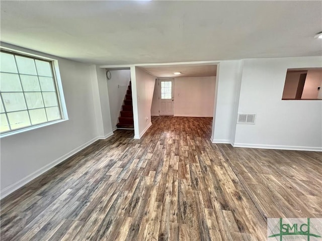 spare room with dark hardwood / wood-style floors and a wealth of natural light