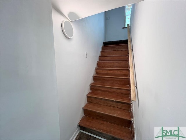 stairway with hardwood / wood-style flooring