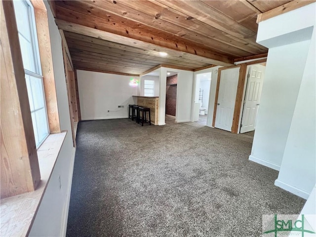 additional living space with dark carpet and wood ceiling