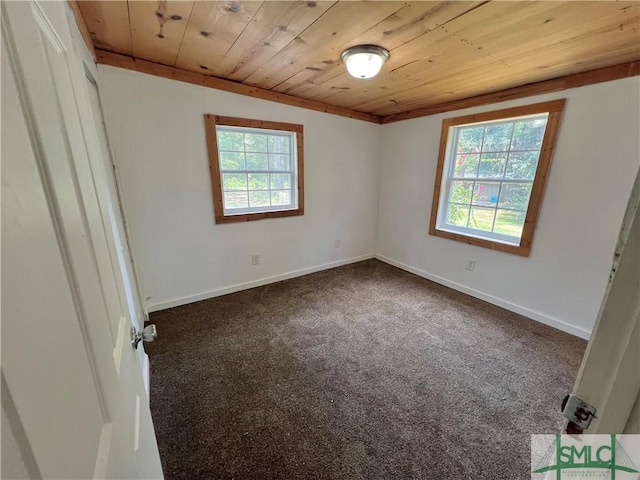 interior space with crown molding, wood ceiling, and dark colored carpet