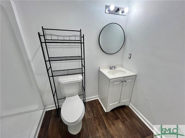 bathroom featuring wood-type flooring, vanity, and toilet