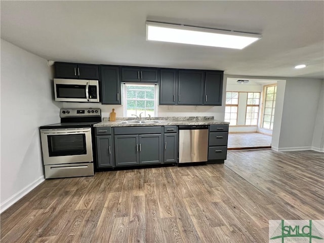 kitchen featuring sink, stainless steel appliances, and light hardwood / wood-style floors