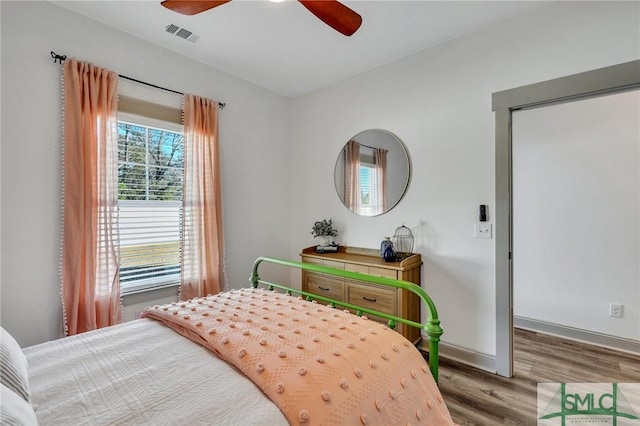 bedroom with ceiling fan and hardwood / wood-style flooring