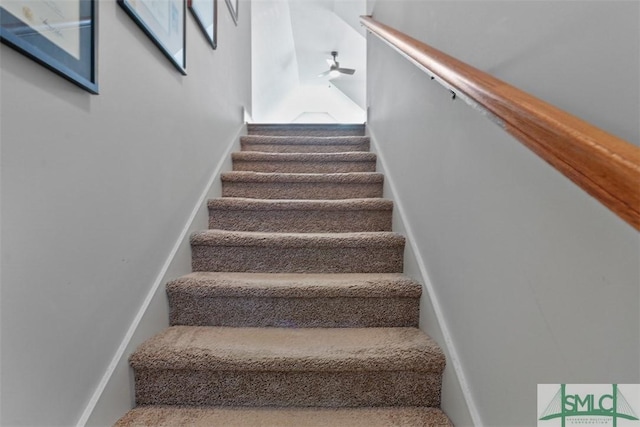 staircase featuring ceiling fan