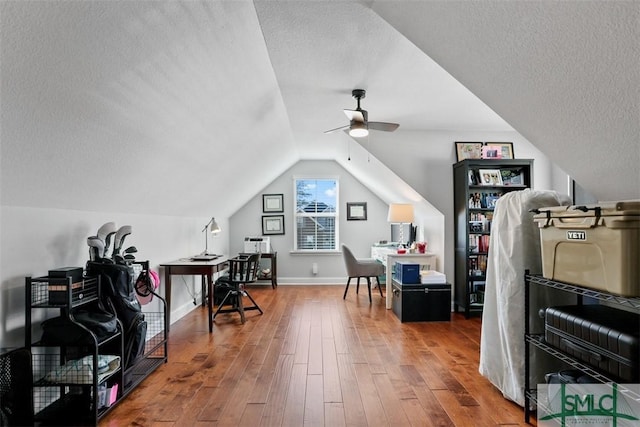 office with a textured ceiling, ceiling fan, hardwood / wood-style floors, and vaulted ceiling