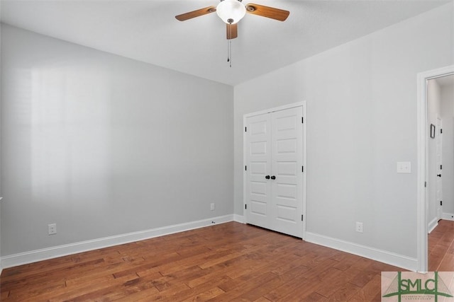 unfurnished room with ceiling fan and hardwood / wood-style floors