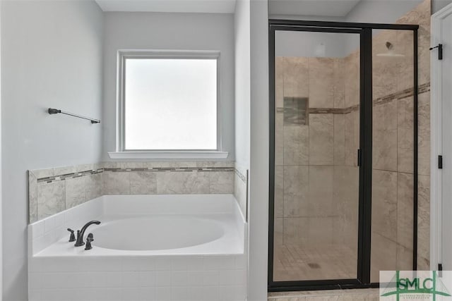 bathroom featuring separate shower and tub