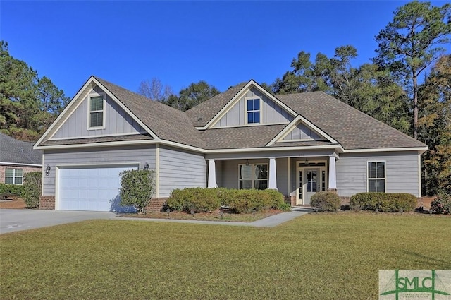 view of front of home featuring a porch, a front yard, and a garage