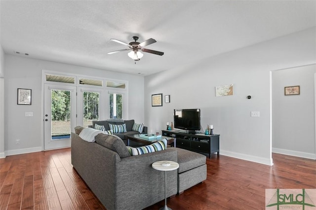 living room featuring ceiling fan and dark hardwood / wood-style floors