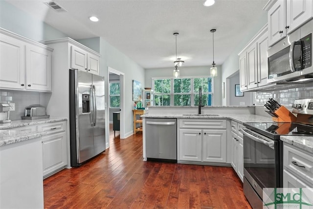 kitchen featuring backsplash, sink, white cabinetry, and stainless steel appliances