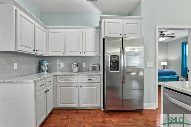 kitchen featuring stainless steel appliances, white cabinetry, and ceiling fan