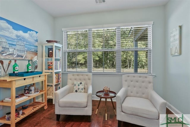 sitting room with dark wood-type flooring