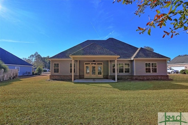 back of property with ceiling fan, a patio area, and a lawn