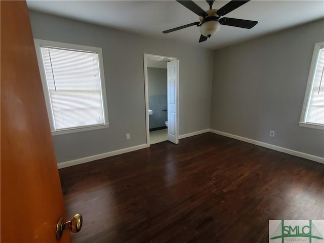 empty room with ceiling fan and dark wood-type flooring