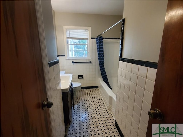 full bathroom featuring shower / tub combo with curtain, vanity, tile walls, and toilet