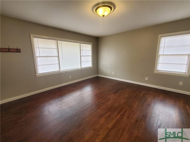 spare room with dark wood-type flooring