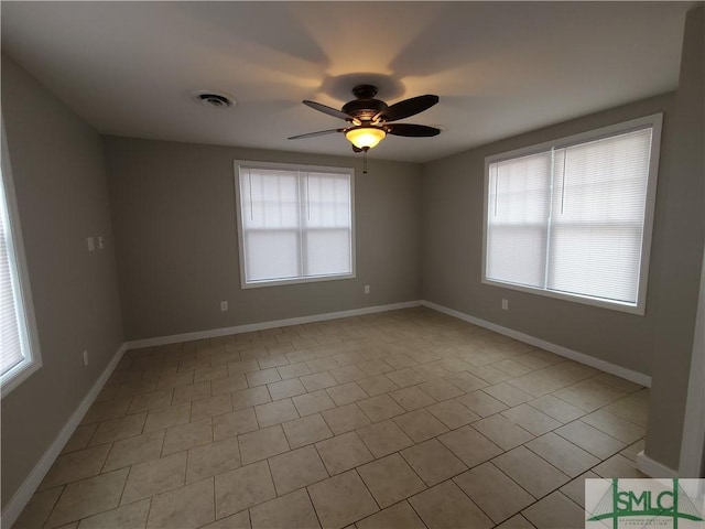 tiled empty room with ceiling fan