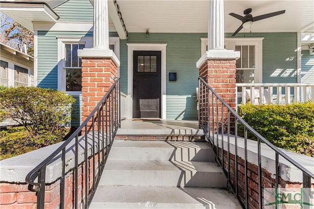 doorway to property featuring covered porch and ceiling fan