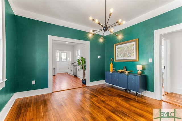 interior space featuring hardwood / wood-style flooring and an inviting chandelier