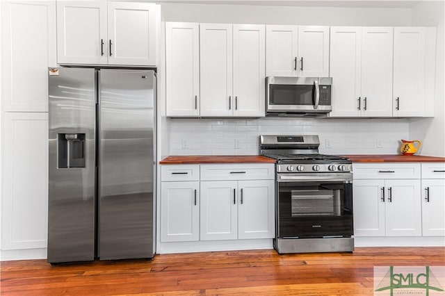 kitchen with white cabinetry, light hardwood / wood-style flooring, and stainless steel appliances