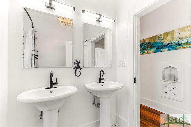 bathroom with hardwood / wood-style flooring and double sink