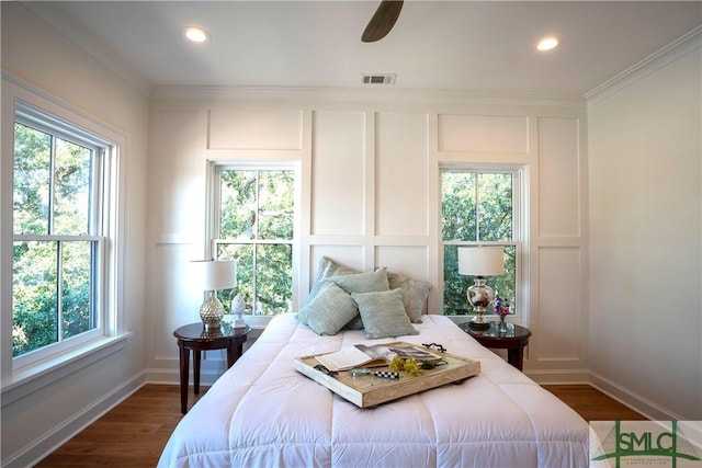 bedroom with multiple windows, ceiling fan, and ornamental molding