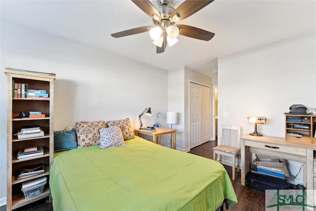 bedroom featuring dark hardwood / wood-style flooring, ceiling fan, and a closet