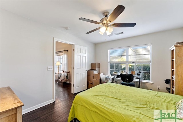 bedroom with ceiling fan and dark hardwood / wood-style flooring