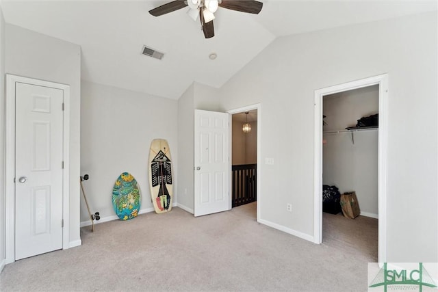 unfurnished bedroom featuring ceiling fan, light carpet, and lofted ceiling