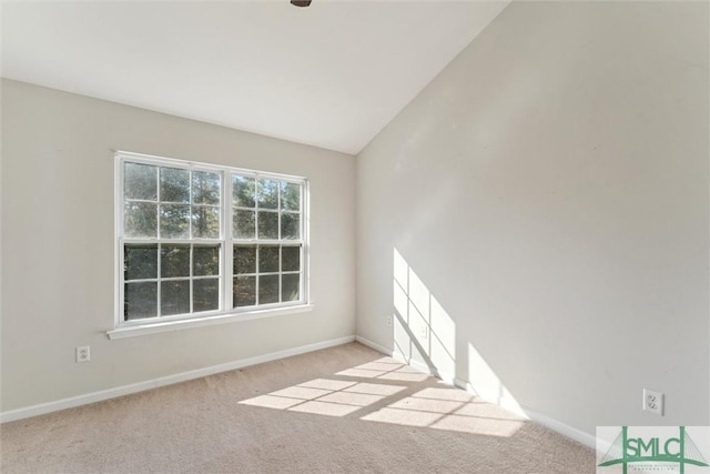 empty room featuring light carpet and lofted ceiling