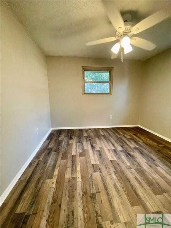 spare room featuring ceiling fan, dark hardwood / wood-style flooring, and a textured ceiling