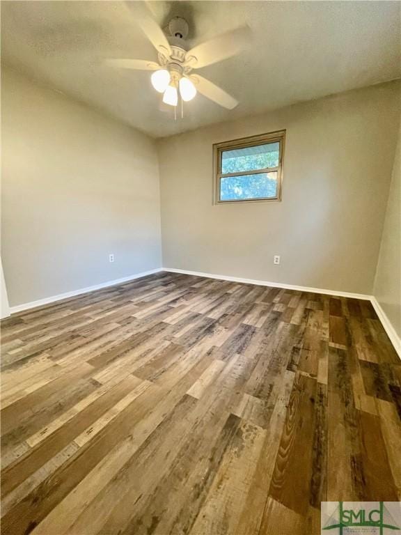 spare room with hardwood / wood-style floors and ceiling fan