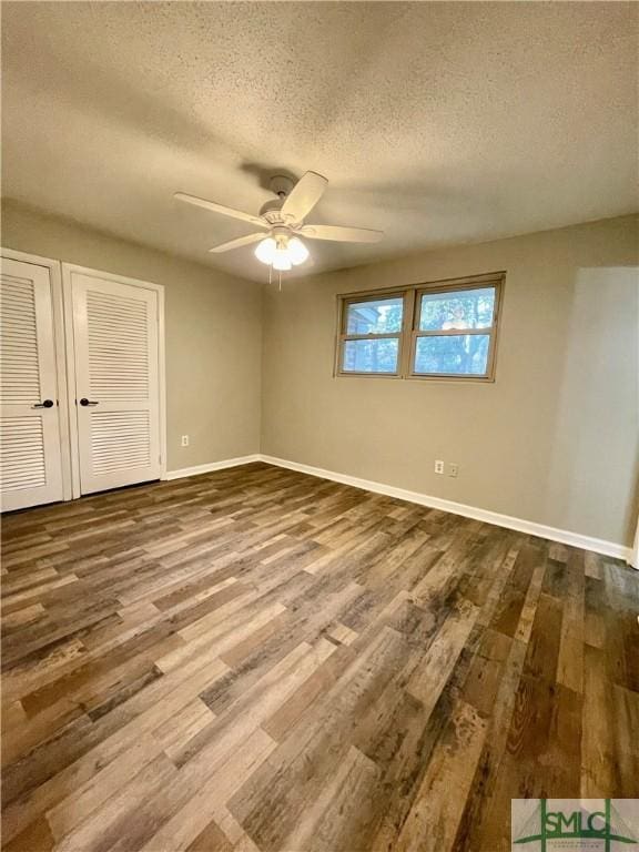 unfurnished room with hardwood / wood-style floors, ceiling fan, and a textured ceiling