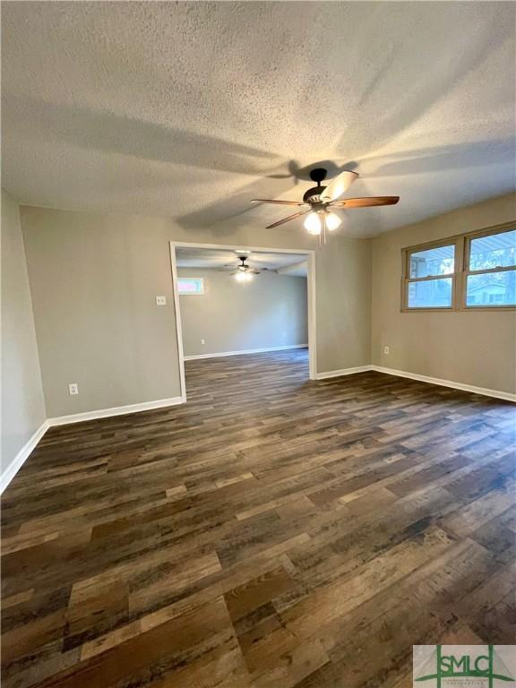 unfurnished room with dark hardwood / wood-style floors, ceiling fan, and a textured ceiling