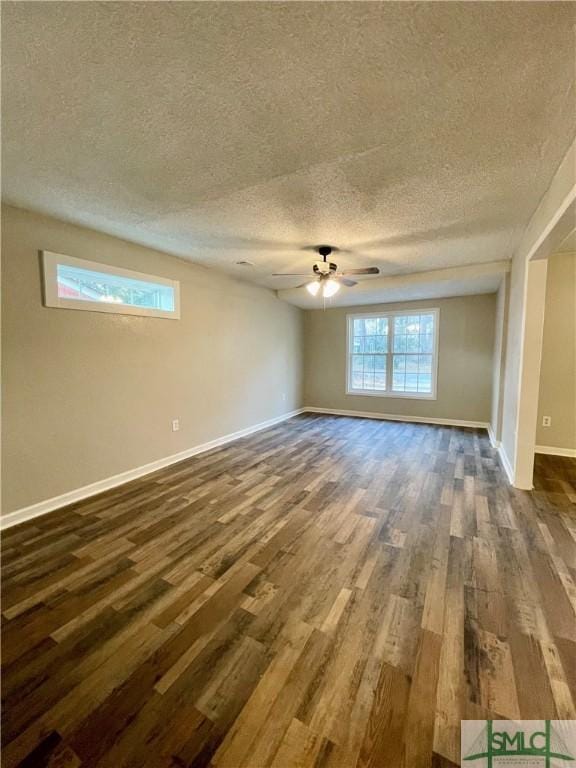 unfurnished room featuring a textured ceiling, ceiling fan, and dark wood-type flooring