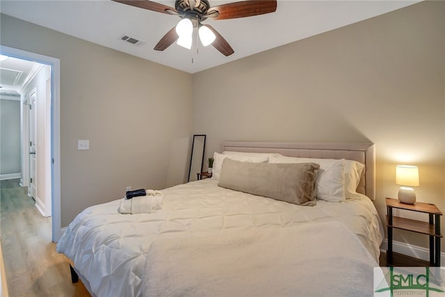 bedroom with ceiling fan and wood-type flooring