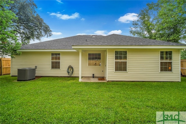 back of house featuring central AC, a yard, and a patio