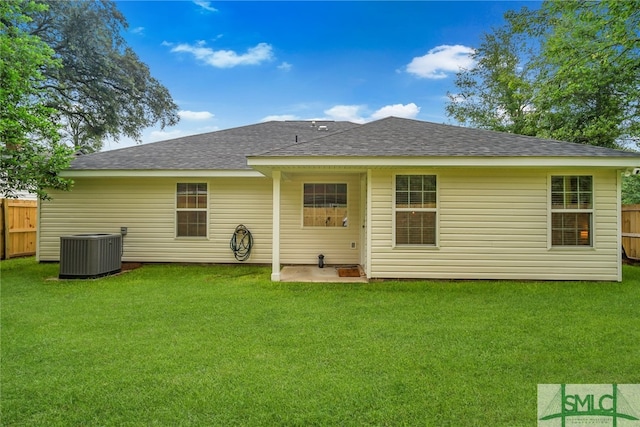 back of house with a lawn, cooling unit, and a patio